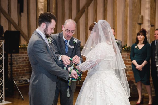 Civil celebrant handfasting a wedding couple