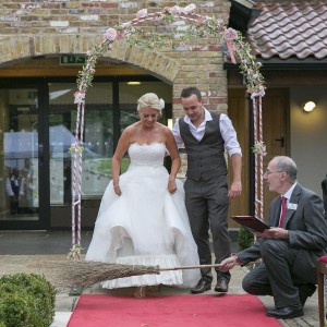 At a wedding blessing ceremony - jumping the broom